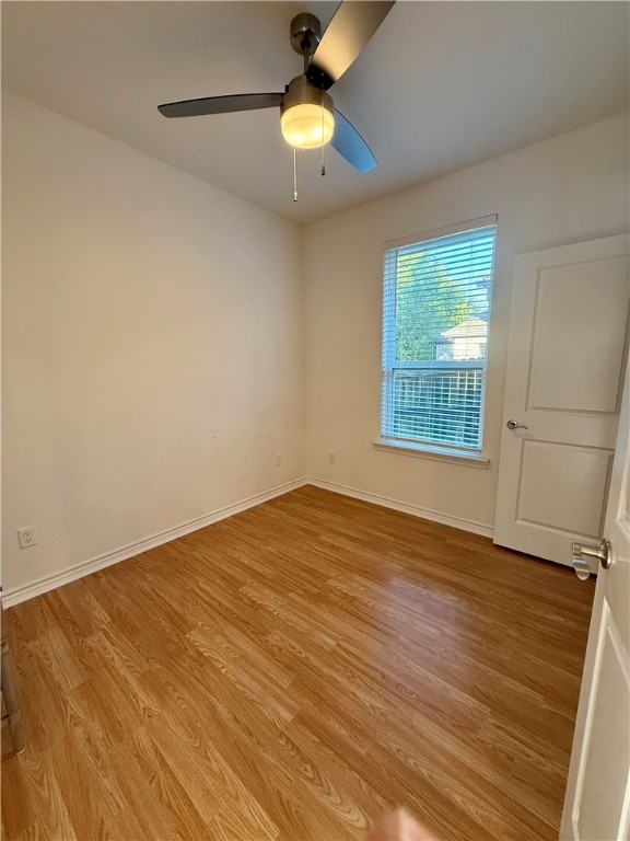3533 Leesburg Path Bryan, TX 77808 - Photo 11 of 28 wooden floor in an empty room with a window