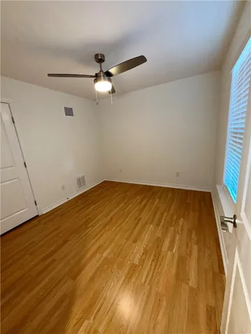 a view of room with wooden floor