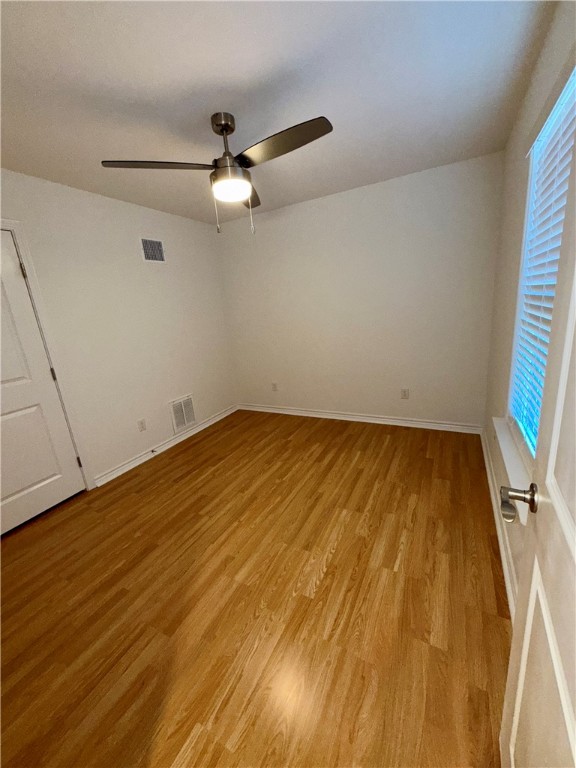 3533 Leesburg Path Bryan, TX 77808 - Photo 18 of 28 an empty room with wooden floor and fan