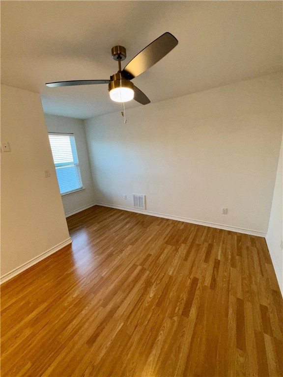 3533 Leesburg Path Bryan, TX 77808 - Photo 21 of 28 an empty room with wooden floor fan and windows