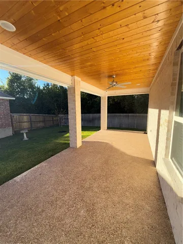 a bathroom with a granite countertop sink a toilet and a mirror