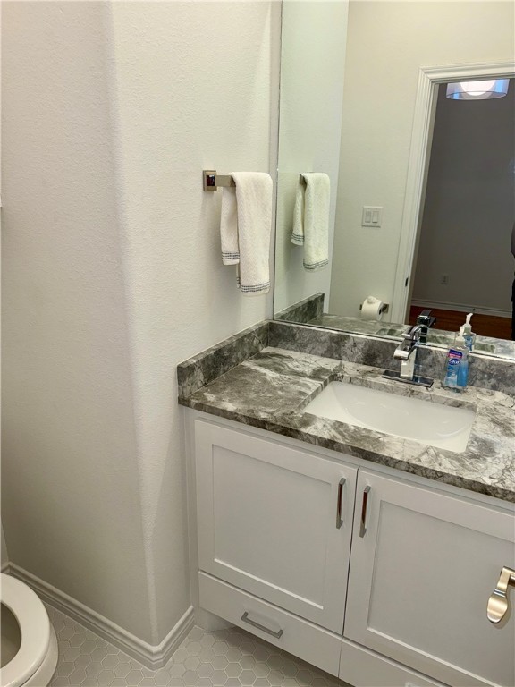3533 Leesburg Path Bryan, TX 77808 - Photo 25 of 28 a bathroom with a granite countertop sink and a mirror