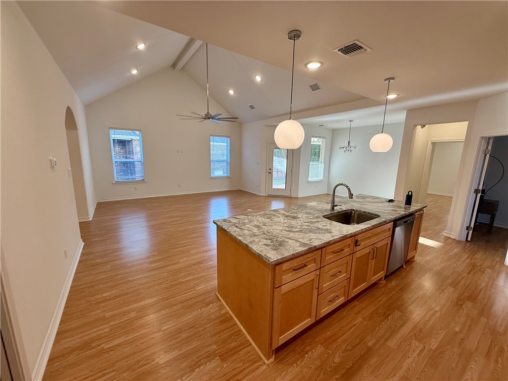 3533 Leesburg Path Bryan, TX 77808 - Photo 27 of 28 a large kitchen with a stove and wooden floor