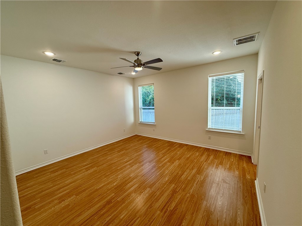 3533 Leesburg Path Bryan, TX 77808 - Photo 7 of 28 wooden floor in an empty room with a window