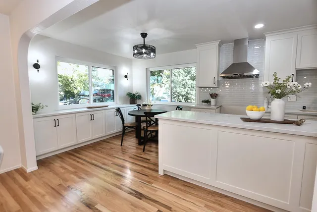 a kitchen with a sink a refrigerator and cabinets