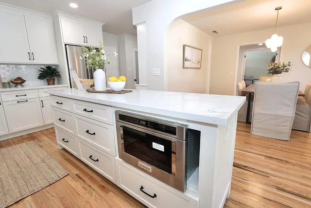 a spacious bedroom with a bed and a chandelier