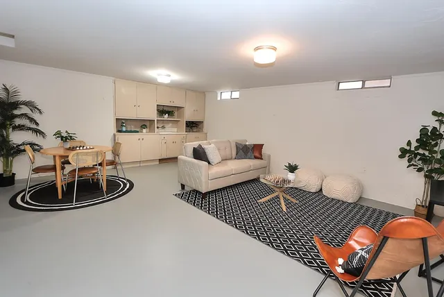 a view of a backyard with a plants and large tree