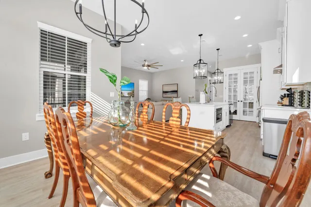 a living room with furniture a desk and a chandelier