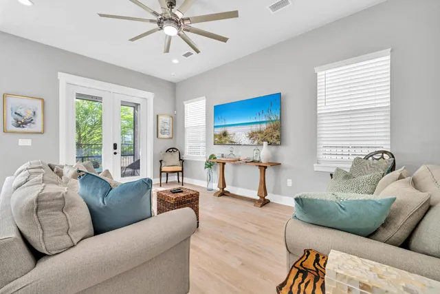a living room with furniture and a chandelier