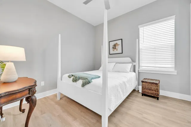 a bedroom with a bed and wooden floor