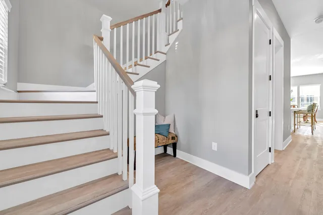 a view of entryway and hall with wooden floor