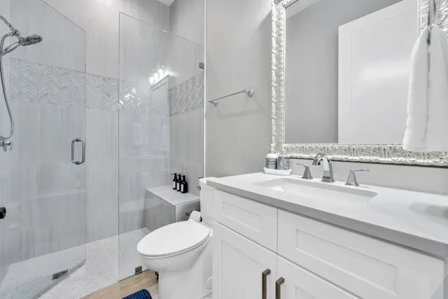 a bathroom with a sink toilet and shower