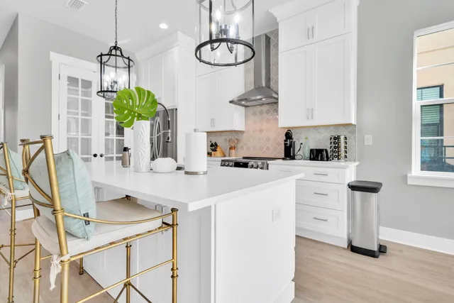 a kitchen with kitchen island granite countertop a sink a counter space appliances and cabinets