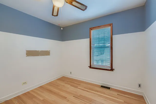 a view of room with window and ceiling fan