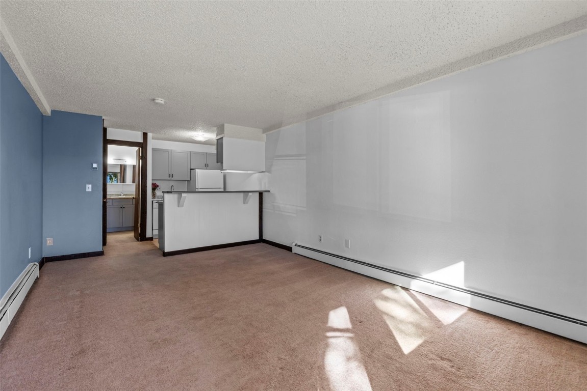 7307 Ryan Gulch Road, Unit 7307 Silverthorne, CO 80498 - Photo 15 of 20 a view of a big room with a fireplace