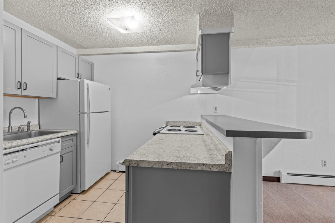 7307 Ryan Gulch Road, Unit 7307 Silverthorne, CO 80498 - Photo 7 of 20 a kitchen with stainless steel appliances granite countertop a sink stove and refrigerator