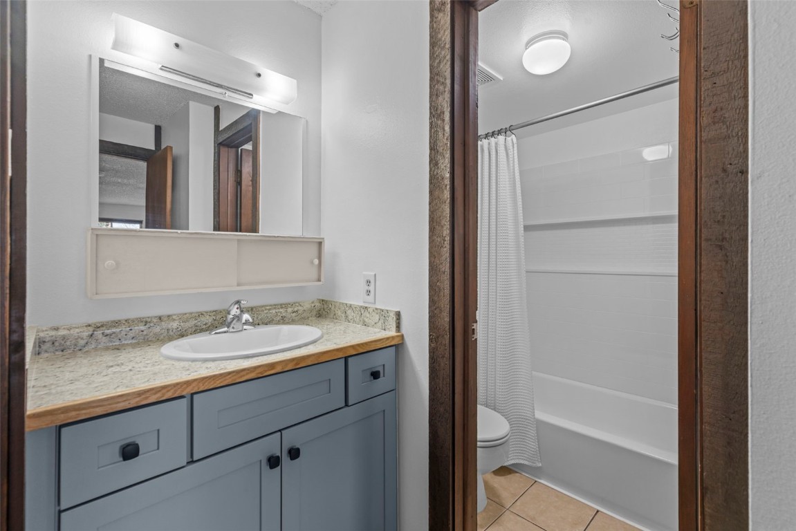 7307 Ryan Gulch Road, Unit 7307 Silverthorne, CO 80498 - Photo 10 of 20 a bathroom with a granite countertop sink toilet and shower