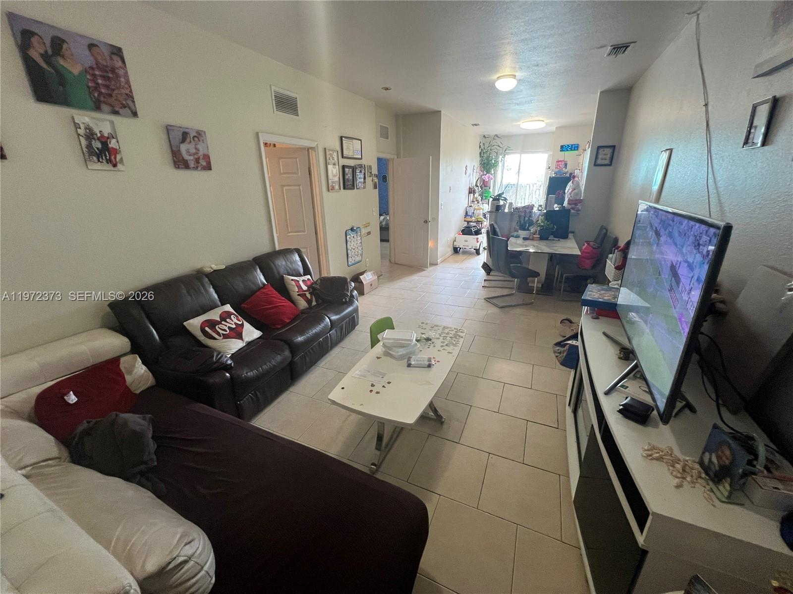 45 Southwest 14th Terrace Homestead, FL 33030 - Photo 16 of 40 a living room with furniture and a flat screen tv