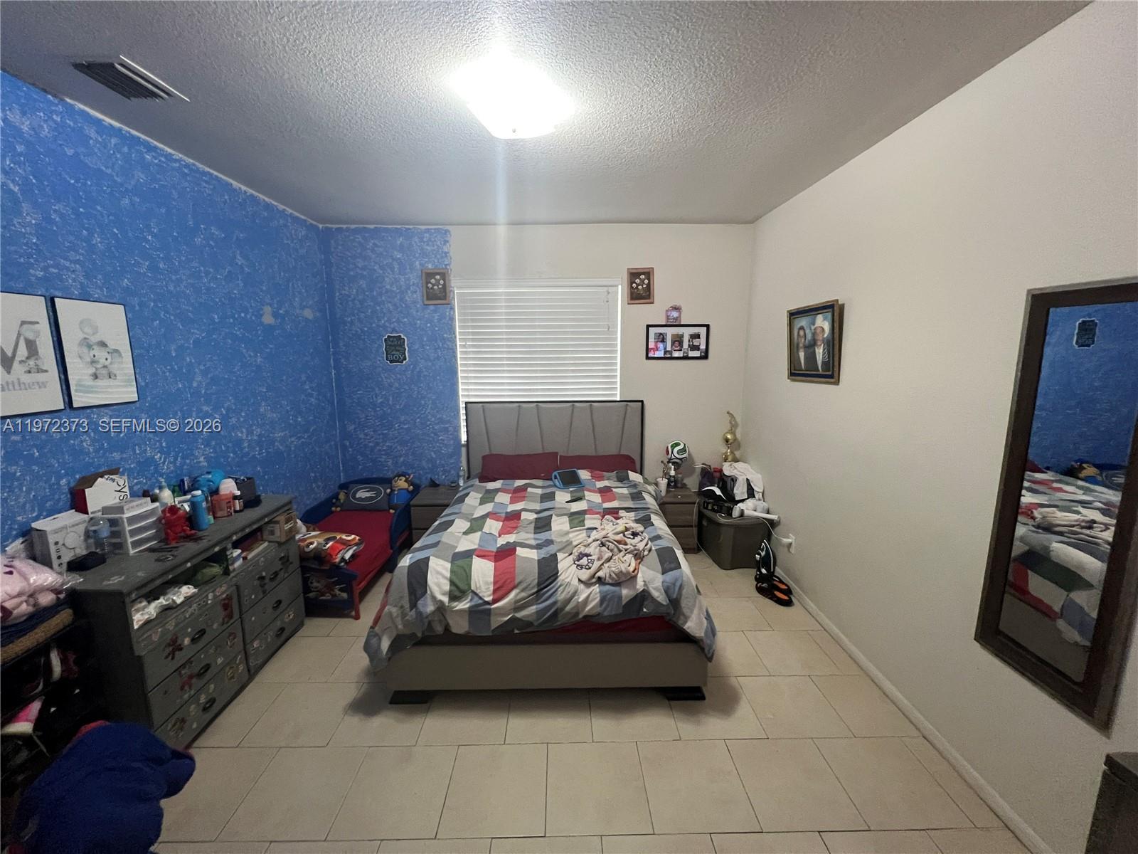45 Southwest 14th Terrace Homestead, FL 33030 - Photo 20 of 40 a bedroom with furniture and a tv