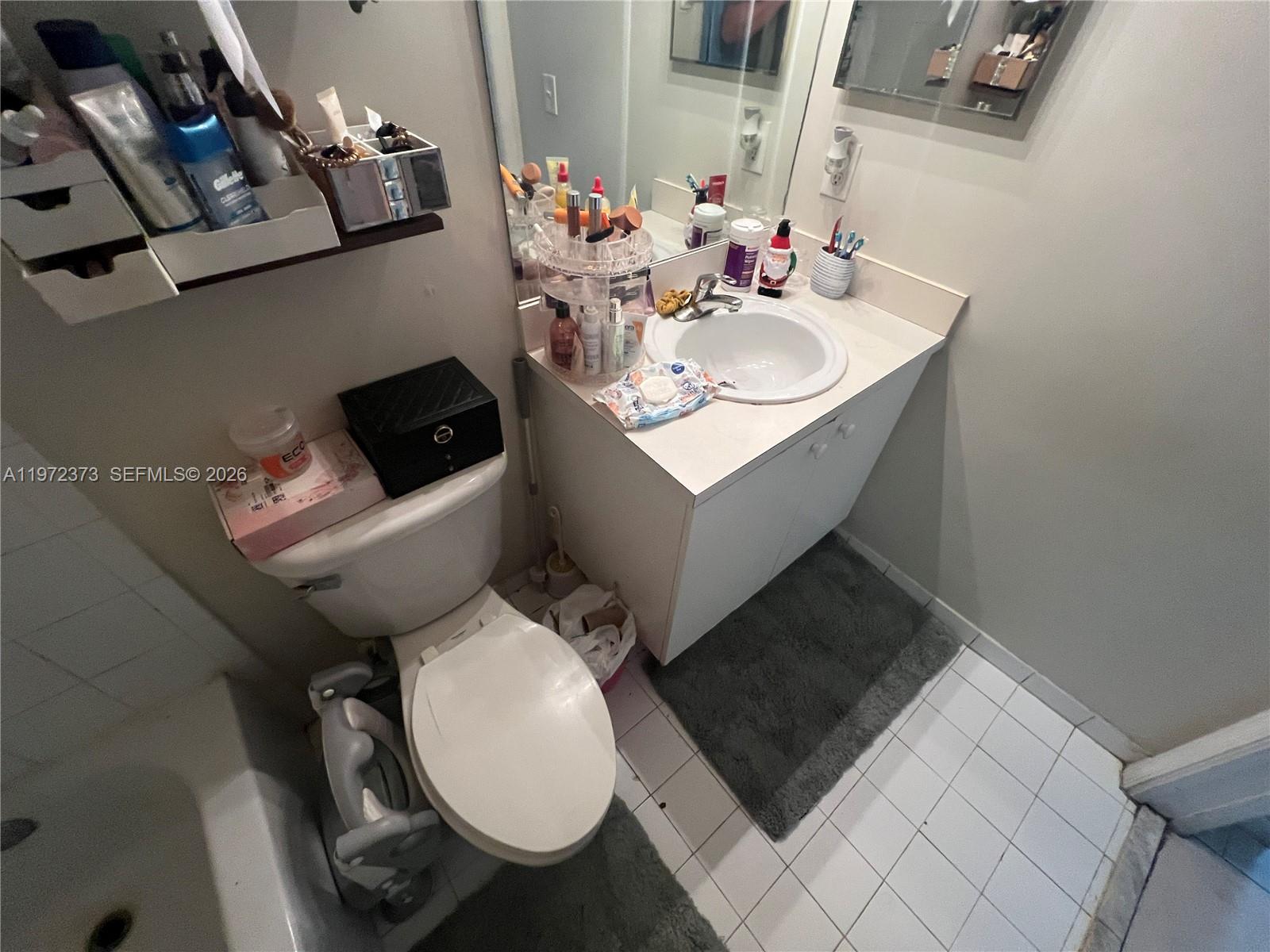 45 Southwest 14th Terrace Homestead, FL 33030 - Photo 27 of 40 a bathroom with a toilet sink and mirror