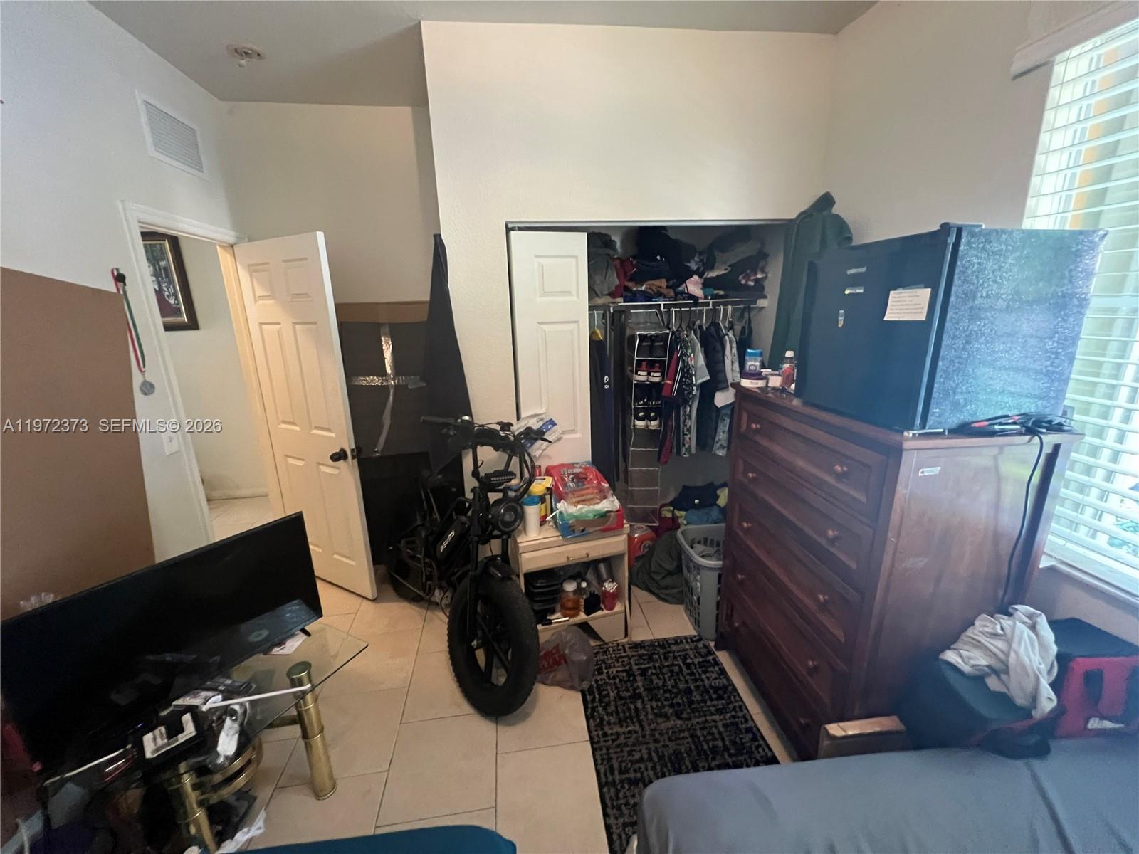 45 Southwest 14th Terrace Homestead, FL 33030 - Photo 32 of 40 a room with furniture a rug and a window