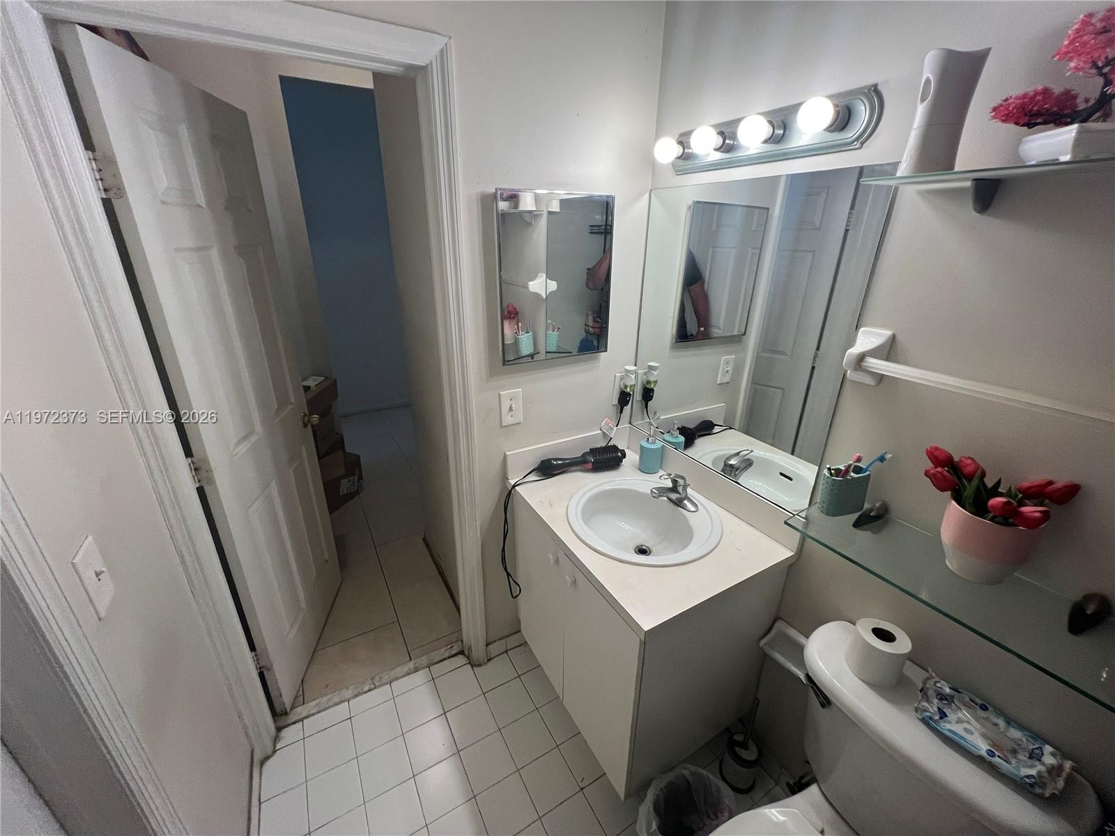 45 Southwest 14th Terrace Homestead, FL 33030 - Photo 39 of 40 a bathroom with a sink toilet and mirror