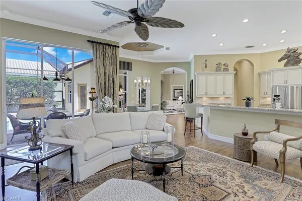 a living room with furniture a rug and white walls
