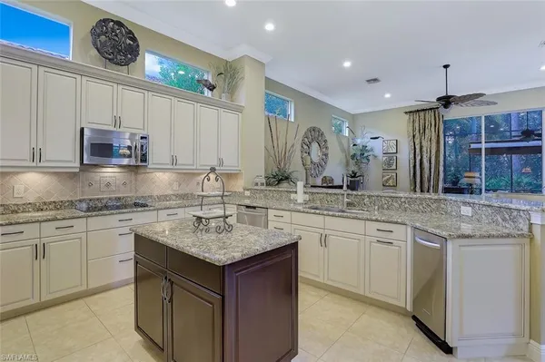 a kitchen with stainless steel appliances granite countertop a sink stove and cabinets