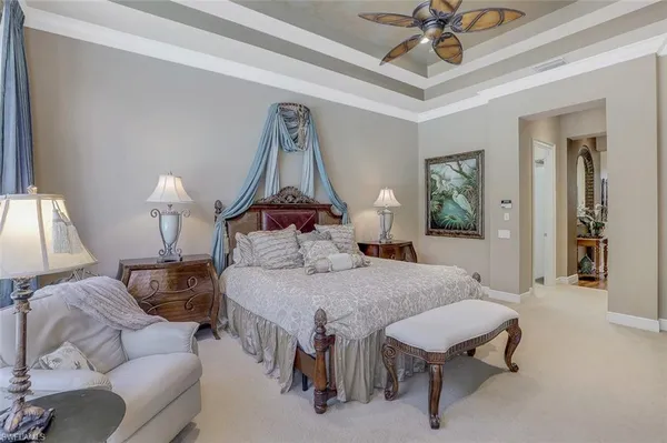 a bedroom with a bed and a chandelier