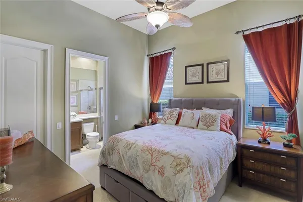 a bedroom with a bed and a flat tv screen on dresser