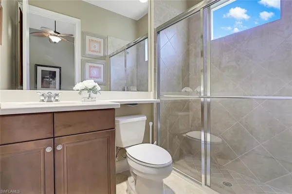 a bathroom with a sink vanity mirror and toilet