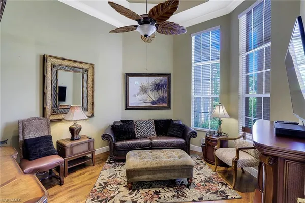 a living room with furniture ceiling fan and a window