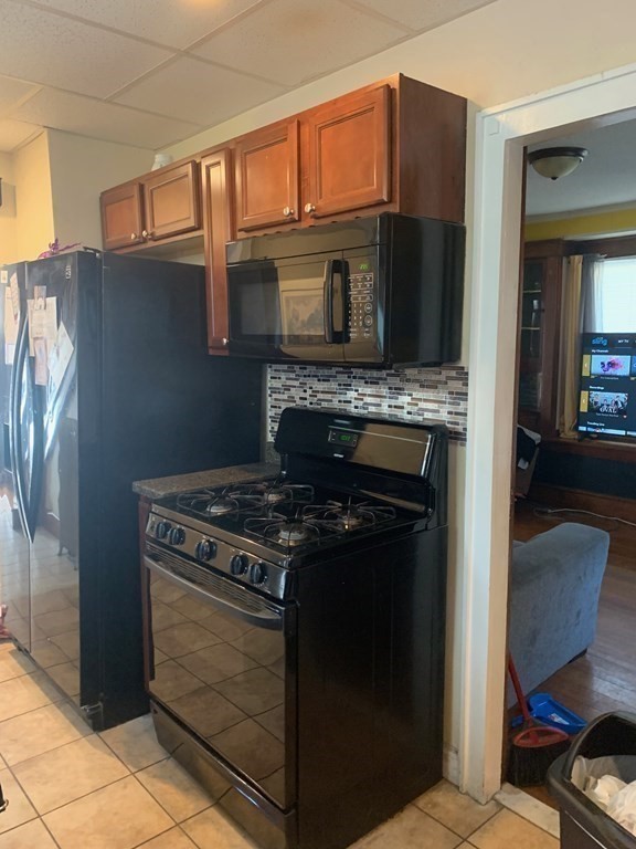 99 Littleton Street Springfield, MA 01104 - Photo 8 of 26 a kitchen with a stove and a microwave