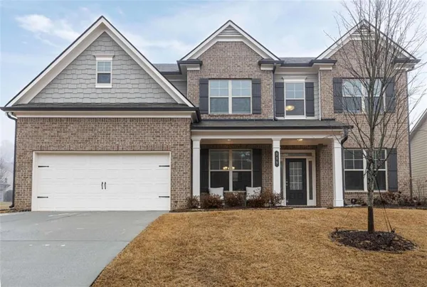 a front view of a house with a yard and garage