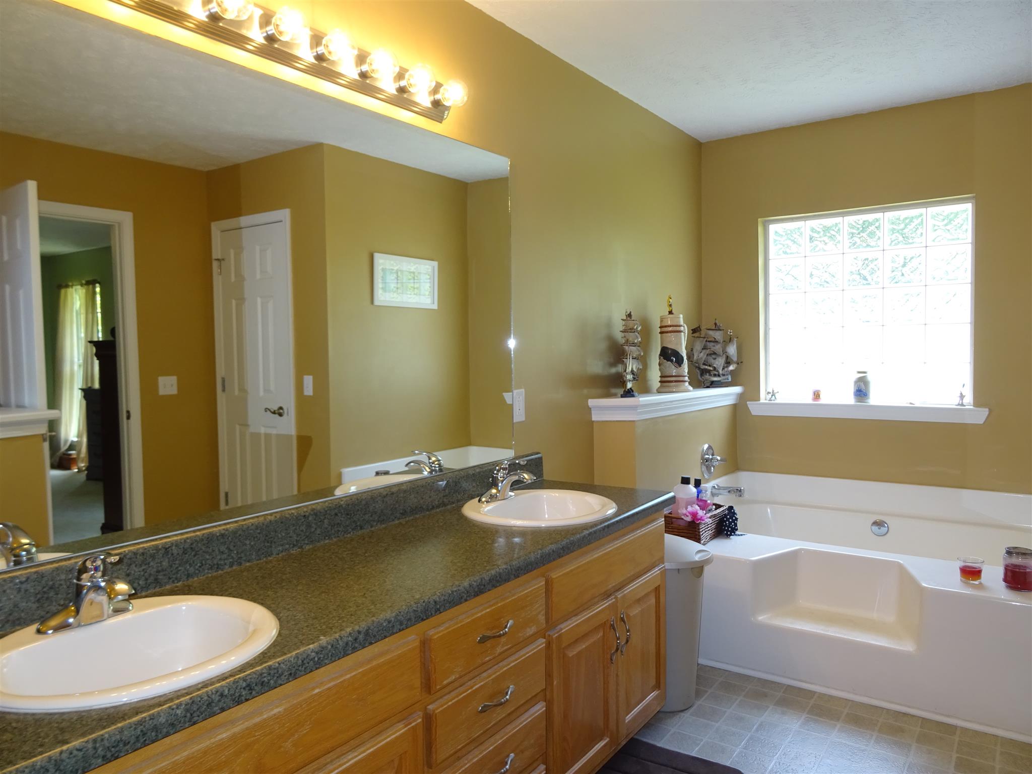 1246 Dillon Road Milton, TN 37118 - Photo 11 of 29 a bathroom with a granite countertop sink and a mirror