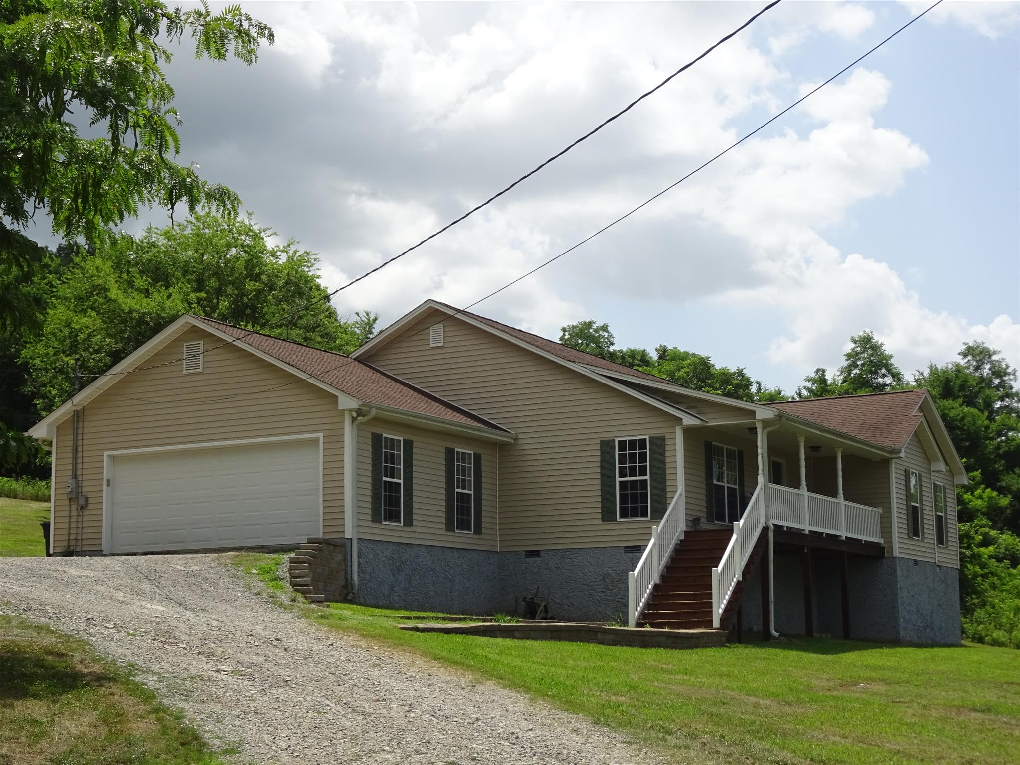 1246 Dillon Road Milton, TN 37118 - Photo 26 of 29 a view of a yard in front of a house with plants and large tree