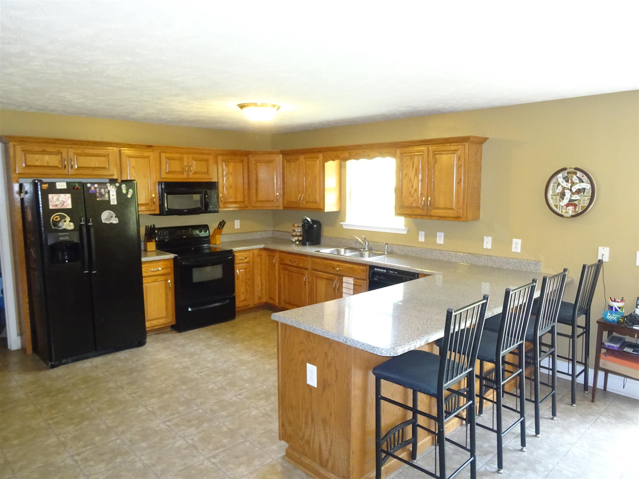 1246 Dillon Road Milton, TN 37118 - Photo 4 of 29 a kitchen with stainless steel appliances granite countertop a sink a stove a refrigerator with a dining table and chairs