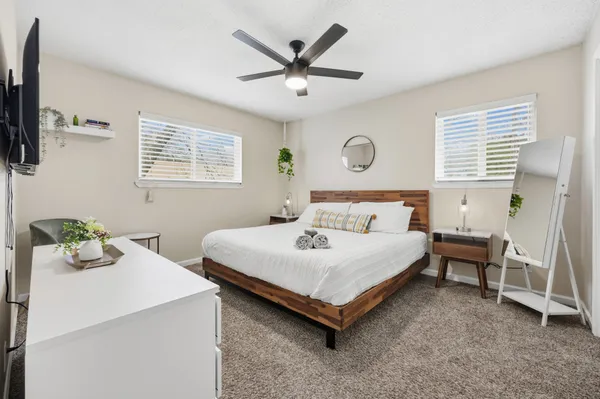 a bedroom with a bed and a window