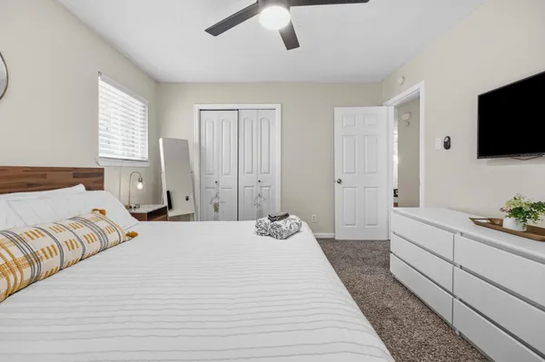 a bedroom with a large bed and a flat screen tv