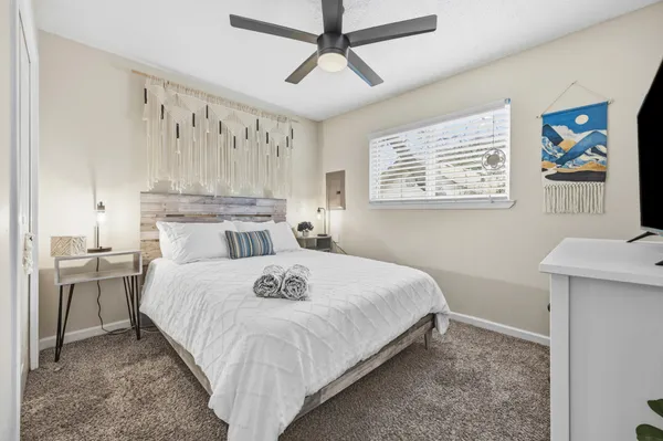 a bedroom with a bed and a table in it