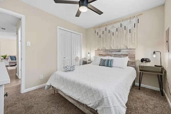 a bedroom with a bed and a chandelier