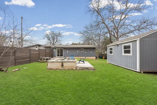 a front view of a house with garden and yard