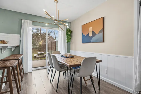 a view of a dining room with furniture wooden floor and a chandelier