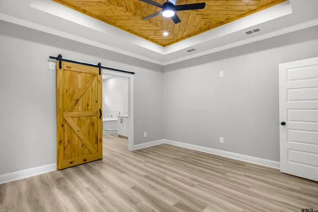 a view of a room with wooden floor