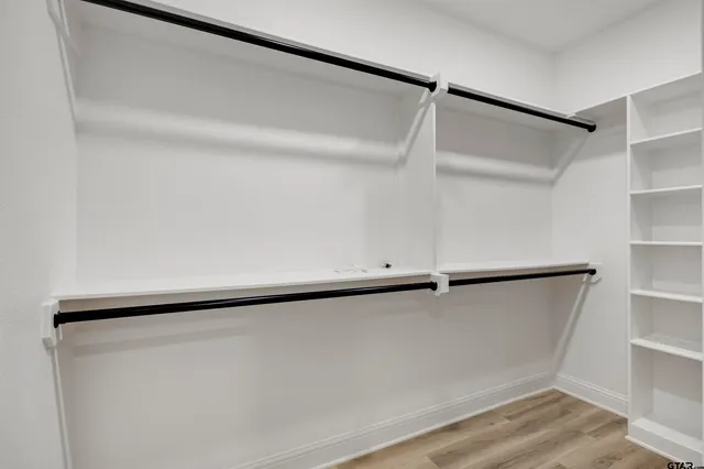 a bathroom with a sink a vanity a mirror and a bathtub