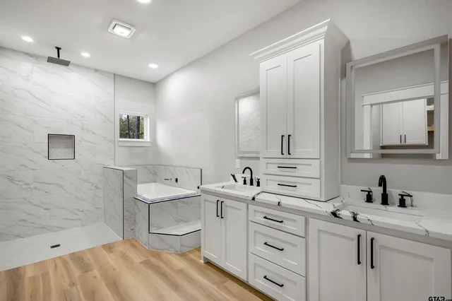 a view of white cabinets and wooden floor