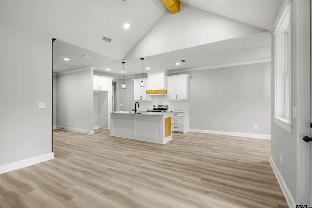 a view of kitchen with cabinets appliances and wooden floor
