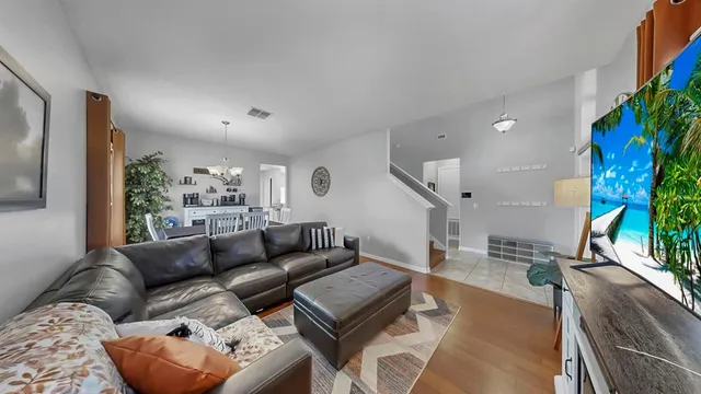 a living room with furniture and a potted plant