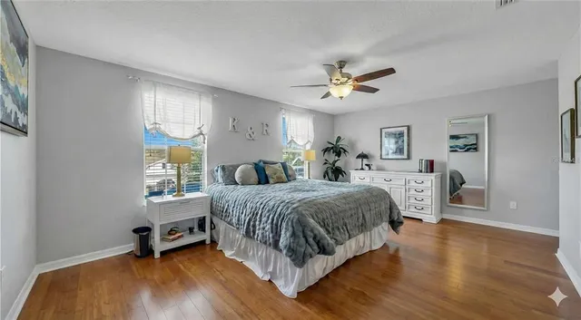 a bedroom with a bed a chandelier and a window