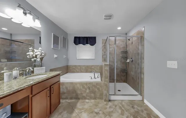 a bathroom with a tub sink and mirror